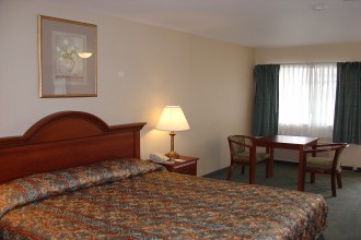 California King Bed with accessibility features at Country Inn